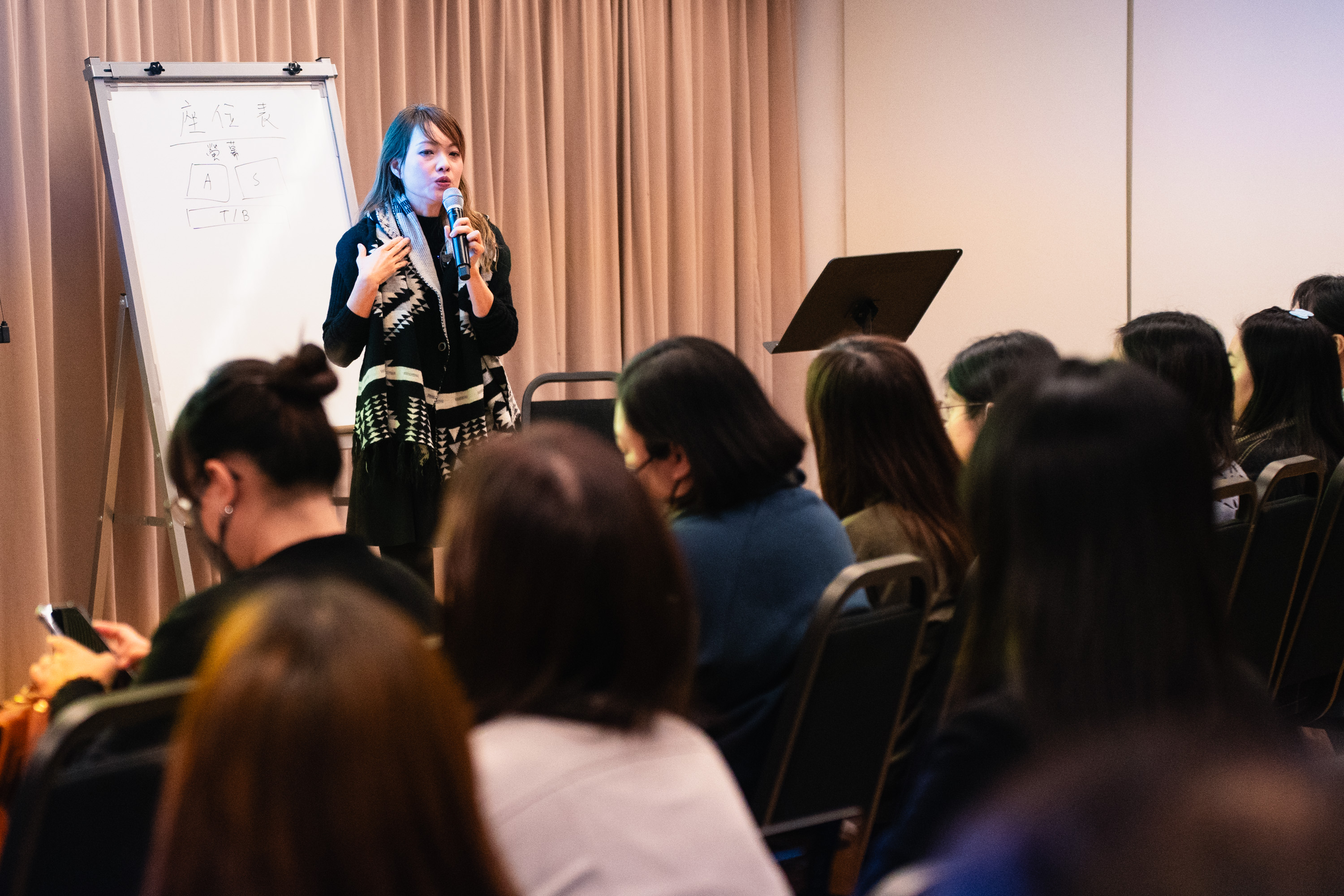 An HKVC vocal coach leading an adult choral workshop
